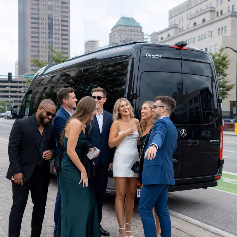 Group boarding a white charter bus for Bachelor & Bachelorette Transportation transportation in Fort Wayne