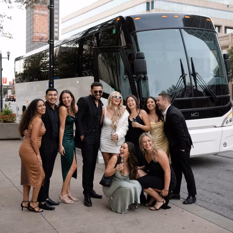 Passengers loading luggage while boarding an Fort Wayne group shuttle