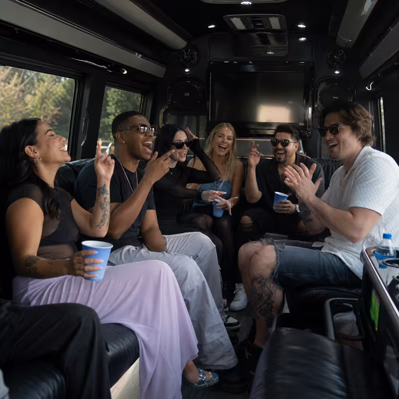 Group boarding a white charter bus for Concert Transportation transportation in Fort Wayne