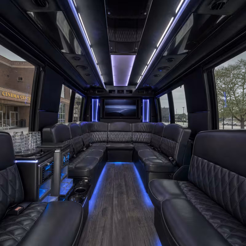 Party bus interior with wraparound leather seating and LED lighting in Fort Wayne