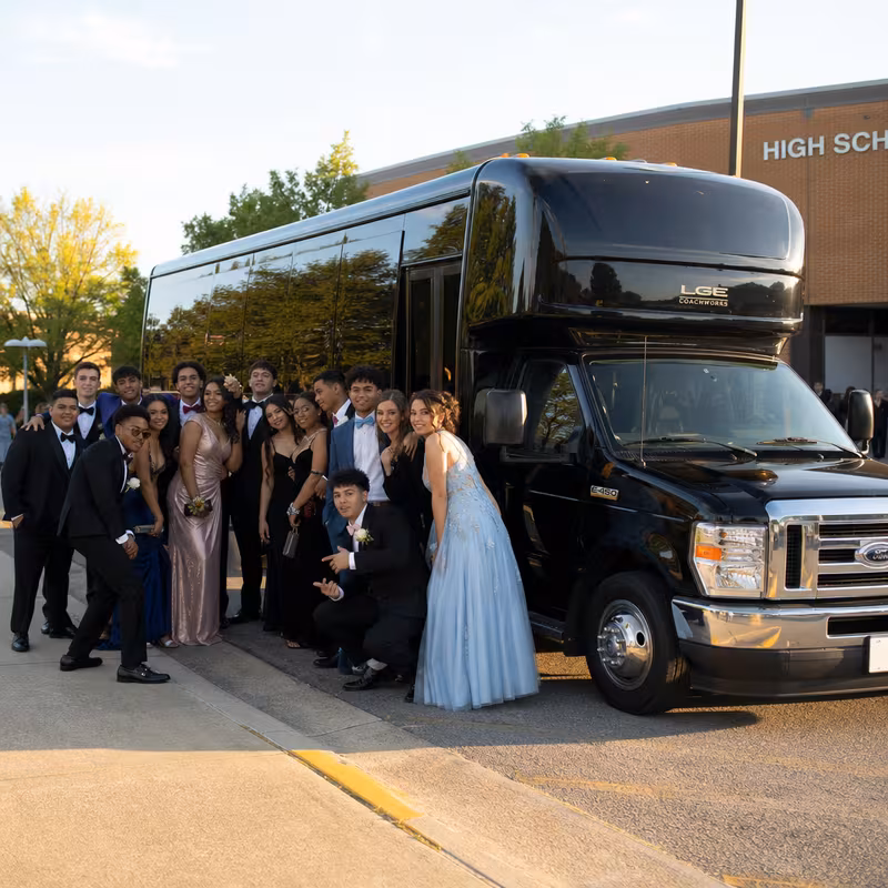 Group boarding a white charter bus for Prom & Homecoming Transportation transportation in Fort Wayne