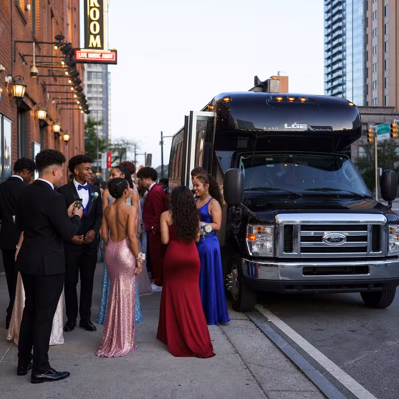Passengers loading luggage while boarding an Fort Wayne group shuttle