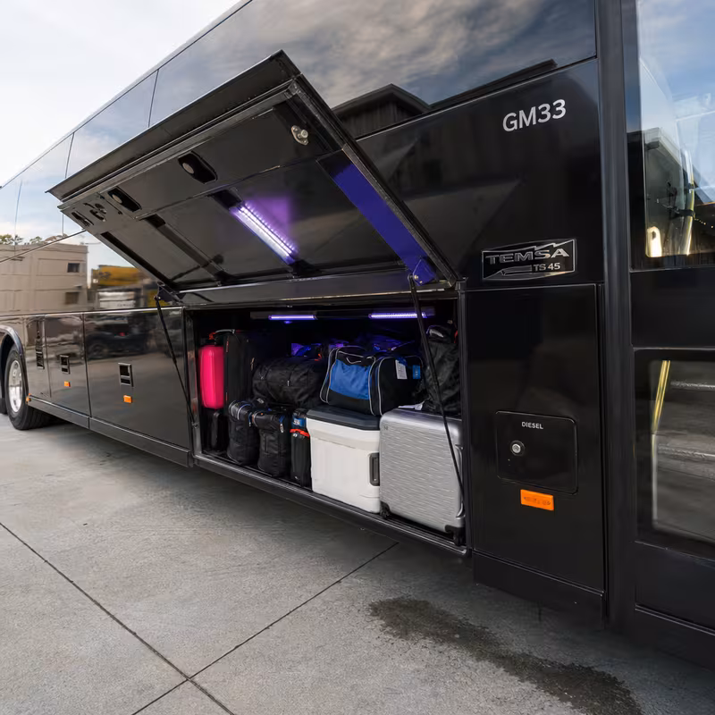 Party bus interior with wraparound leather seating and LED lighting in Fort Wayne