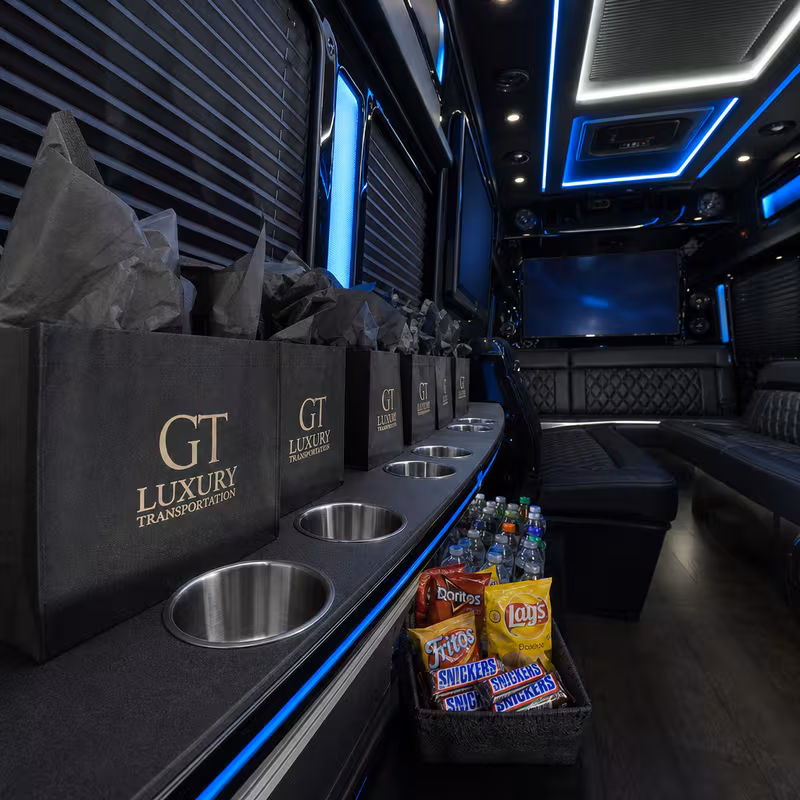 Party bus interior with wraparound leather seating and LED lighting in Fort Wayne