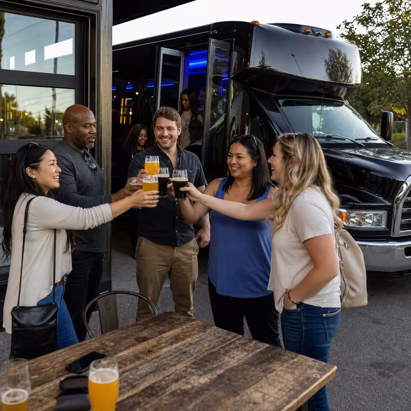 Passengers loading luggage while boarding an Fort Wayne group shuttle